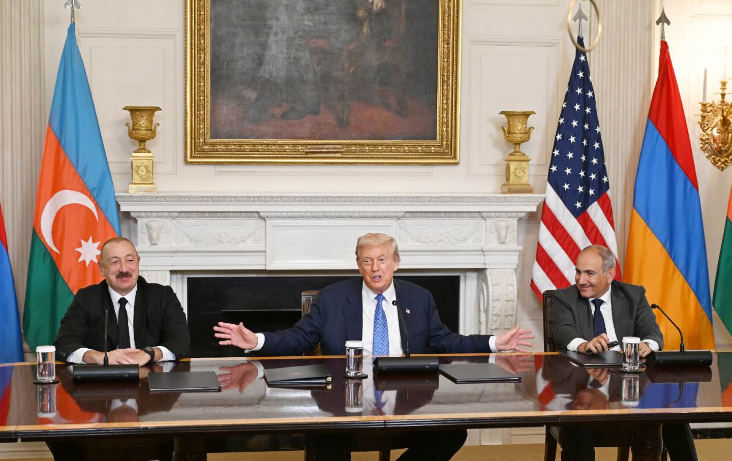 U.S. President Donald Trump (C), Azerbaijani President Ilham Aliyev (L), and Armenian Prime Minister Nikol Pashinyan (R) sign the joint declaration 'peace roadmap' following their trilateral meeting at the White House in Washington D.C., United States on August 08, 2025.